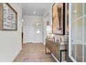 Light-filled entryway with hardwood floors, console table and modern wall art at 120 Asher Dr, Carrollton, GA 30116