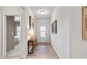 Bright and airy foyer with hardwood floors, console table, and view of bedroom at 120 Asher Dr, Carrollton, GA 30116