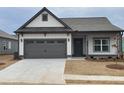 Charming single-Gathering home featuring a two-car garage, manicured lawn, and craftsman-style details at 120 Asher Dr, Carrollton, GA 30116