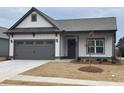 Craftsman style home with gray roof and white and gray siding, two car garage and manicured lawn at 120 Asher Dr, Carrollton, GA 30116