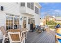 Outdoor deck featuring a seating area with grill, and dining furniture, perfect for entertaining and relaxation at 775 River Cliff Ct, Suwanee, GA 30024