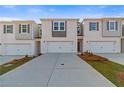 Modern townhome exterior featuring garages, neutral paint, and well-maintained landscaping at 317 Heavenly Hollow Pl, Mcdonough, GA 30253