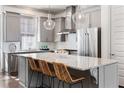 Modern kitchen featuring stainless steel appliances, a large island with seating, and pendant lighting at 607 Broadview Ter, Atlanta, GA 30324