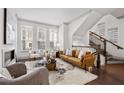 Bright living room with hardwood floors, staircase, large windows, and stylish modern furniture at 607 Broadview Ter, Atlanta, GA 30324
