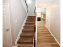 Staircase with brown carpet and wooden railing leading to the second floor at 3301 Cascade Parc Blvd, Atlanta, GA 30311