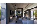 Contemporary living room featuring a linear fireplace, modern furniture, and expansive windows for natural light at 3939 Ivy Rd, Atlanta, GA 30342