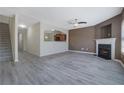 Open concept living room with wood-look floors and access to the staircase at 55 Burns View Ct, Lawrenceville, GA 30044