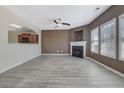 Spacious living room with fireplace, ceiling fan, and ample natural light at 55 Burns View Ct, Lawrenceville, GA 30044