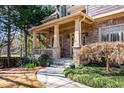 Stone-accented porch and landscaped front yard create a welcoming entrance to this elegant home at 2240 Palmour Ct, Atlanta, GA 30337
