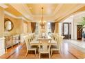 Formal dining room with hardwood floors, chandelier, and large windows at 110 Robinwood Ct, Fayetteville, GA 30214