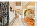 Elegant foyer with decorative tile flooring and a wrought iron accented staircase at 110 Robinwood Ct, Fayetteville, GA 30214