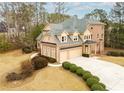 A well-manicured backyard and three-car garage enhance the home's curb appeal at 110 Robinwood Ct, Fayetteville, GA 30214