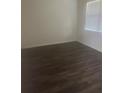 Bright bedroom featuring hardwood floors and a window with light-filtering blinds at 266 Broder Farms Dr, Stockbridge, GA 30281