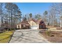 Red brick house with a side view showcasing a two-car garage at 4035 Powerscourt Pl, Suwanee, GA 30024