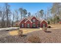 Two-story brick home with a large front yard and mature trees at 4035 Powerscourt Pl, Suwanee, GA 30024