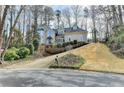 Beautiful home with a winding driveway, stone accents, and lush landscaping at 976 Forest Pond Cir, Marietta, GA 30068