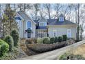 Charming two-story stucco home with a well-manicured lawn and mature trees at 976 Forest Pond Cir, Marietta, GA 30068