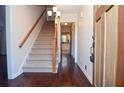 Inviting foyer with hardwood floors, staircase, and a view into the adjacent kitchen at 2265 Pine Point Dr, Lawrenceville, GA 30043