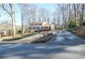 Charming two-story home with a brick facade, long driveway, and mature trees at 2265 Pine Point Dr, Lawrenceville, GA 30043