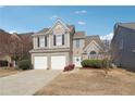 Charming two-story home featuring a well-maintained yard, two-car garage, and neutral color palette at 4035 Crabapple Lake Ct, Roswell, GA 30076