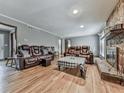 Hardwood floor living room with fireplace and ample seating at 6790 Fairways Dr, Douglasville, GA 30134