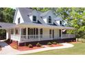 Charming home features a welcoming porch, beautiful landscaping, and fresh curb appeal at 866 Lee Byrd Rd, Loganville, GA 30052