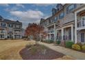 Street view of townhomes with brick exteriors, walkways, and well-maintained landscaping at 2203 Fullers Aly, Kennesaw, GA 30144