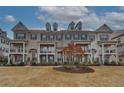 Attractive townhome exteriors showcasing brick, dormers, shutters, and well-manicured landscaping at 2203 Fullers Aly, Kennesaw, GA 30144