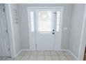 Bright, tiled foyer featuring a white front door with sidelights and neutral wall paint at 2904 Pleasant Ridge Dr, Decatur, GA 30034