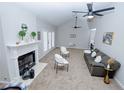 Open-concept living room featuring a fireplace, neutral carpet, and ample space for entertaining at 2904 Pleasant Ridge Dr, Decatur, GA 30034