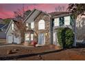Charming two-story home featuring a stone facade, attached garage, and well-maintained landscaping at 473 Silverleaf Ln, Dallas, GA 30157