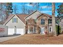 Charming two-story home featuring a stone facade, attached garage, and well-maintained landscaping at 473 Silverleaf Ln, Dallas, GA 30157