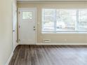 The home's living room area has new laminate floors and a large window at 2096 Snow Sw Rd, Atlanta, GA 30311