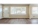 The home's living room area has new laminate floors and large windows at 2096 Snow Sw Rd, Atlanta, GA 30311
