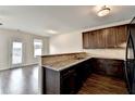 Modern kitchen featuring granite countertops, dark cabinetry, and stainless steel appliances at 5831 Taka Ln, Lithonia, GA 30038