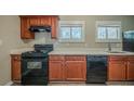 Well-lit kitchen featuring modern black appliances, bright countertops, and wooden cabinets at 2103 Mcafee Rd, Decatur, GA 30032