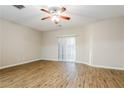 Bright living room with wood floors, ceiling fan, and sliding door access to the exterior at 2229 Bigwood Trl, Atlanta, GA 30349
