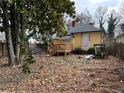 Backyard featuring a wooden deck, mature trees, and plenty of room for outdoor activities and landscaping at 3033 Semmes St, Atlanta, GA 30344