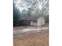 Ranch style home featuring a brick and siding exterior, driveway and a lawn covered with leaves at 7205 Lakeview Dr, Covington, GA 30014