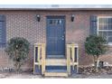 Charming brick home featuring a stylish blue front door and decorative shutters at 1600 Whisperwood Trl, Stone Mountain, GA 30088