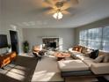 Bright living room features modern furniture, fireplace and large windows that flood the space with natural light at 1600 Whisperwood Trl, Stone Mountain, GA 30088