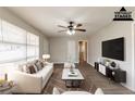 Bright living room features updated flooring, ceiling fan, and large windows at 1754 Shirley Sw St, Atlanta, GA 30310