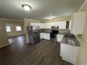 Bright kitchen with stainless steel appliances, granite countertops and white cabinets at 980 Linam Se Ave, Atlanta, GA 30315