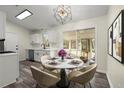 Dining area with a modern chandelier and sliding glass door to the screened in porch at 3753 Adamsville Sw Dr, Atlanta, GA 30331
