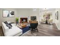 Bright living room with a fireplace, modern furniture, and wood-look flooring at 3753 Adamsville Sw Dr, Atlanta, GA 30331