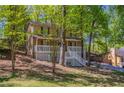 Charming home boasts a welcoming front porch with white railings, surrounded by mature trees and a lush yard at 3500 Quinn Ridge Dr, Snellville, GA 30039