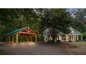 House with a carport and a long driveway leading to the front door at 915 Rocky Creek Rd, Hampton, GA 30228