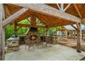 Covered patio with a stone fireplace and built-in grilling station at 915 Rocky Creek Rd, Hampton, GA 30228