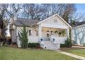 Charming white brick home with a welcoming front porch and well-manicured lawn at 1470 S Gordon Sw St, Atlanta, GA 30310