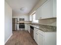 Bright kitchen features stainless appliances, granite counters, and white cabinetry at 2104 Barbara Ln, Decatur, GA 30032